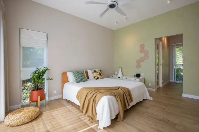 West Bedroom with king bed, workspace and walk-in wardrobe